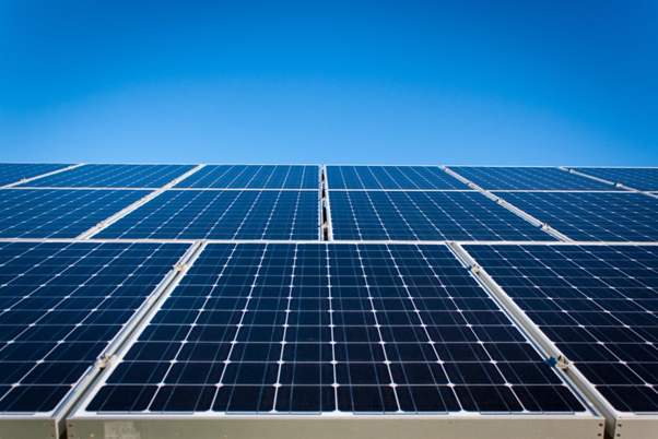 Solar PV installation on a roof with blue sky.